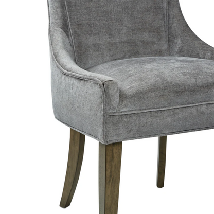 Set of 2 upholstered armless dining chairs in soft grey chenille with high backs, piped detailing, and solid wood legs.

