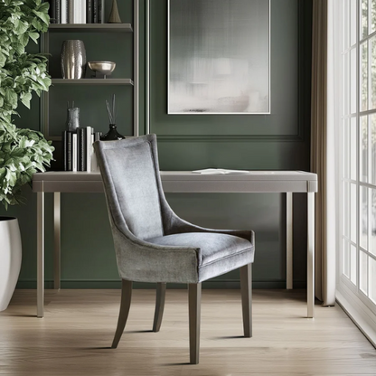 Set of 2 upholstered armless dining chairs in soft grey chenille with high backs, piped detailing, and solid wood legs.


