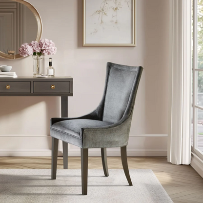 Set of 2 upholstered armless dining chairs in soft grey chenille with high backs, piped detailing, and solid wood legs.

