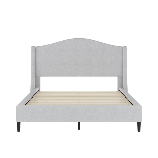 Full-size grey upholstered platform bed with curved wingback headboard, cushioned side rails, and tapered wooden legs in a stylish modern bedroom.

