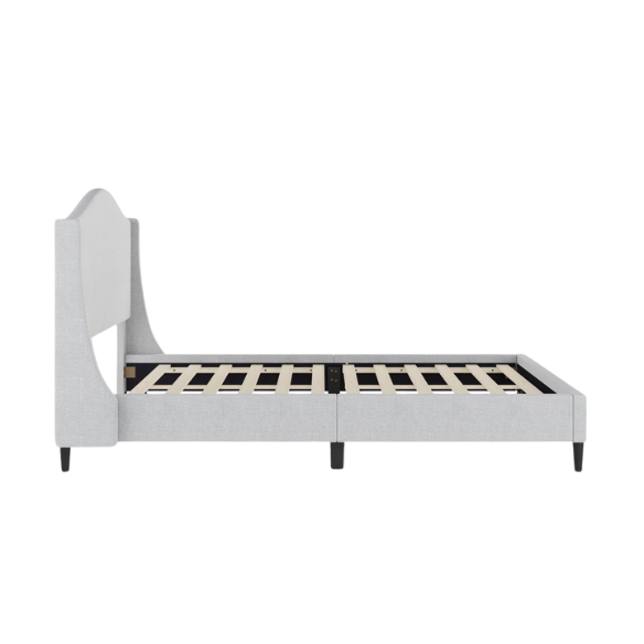 Full-size grey upholstered platform bed with curved wingback headboard, cushioned side rails, and tapered wooden legs in a stylish modern bedroom.

