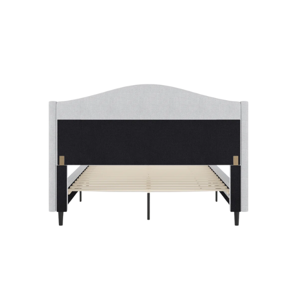 Full-size grey upholstered platform bed with curved wingback headboard, cushioned side rails, and tapered wooden legs in a stylish modern bedroom.

