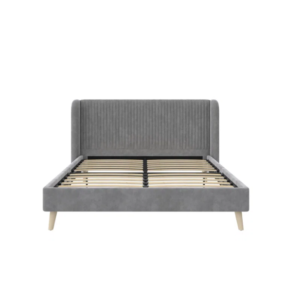 Grey velvet upholstered queen-size platform bed with wingback tufted headboard and mid-century wooden legs.

