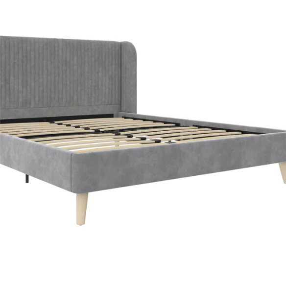 Grey velvet upholstered queen-size platform bed with wingback tufted headboard and mid-century wooden legs.

