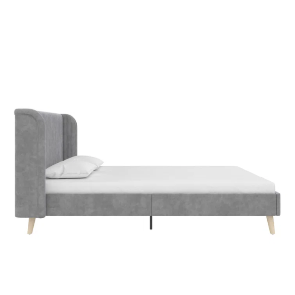 Grey velvet upholstered queen-size platform bed with wingback tufted headboard and mid-century wooden legs.

