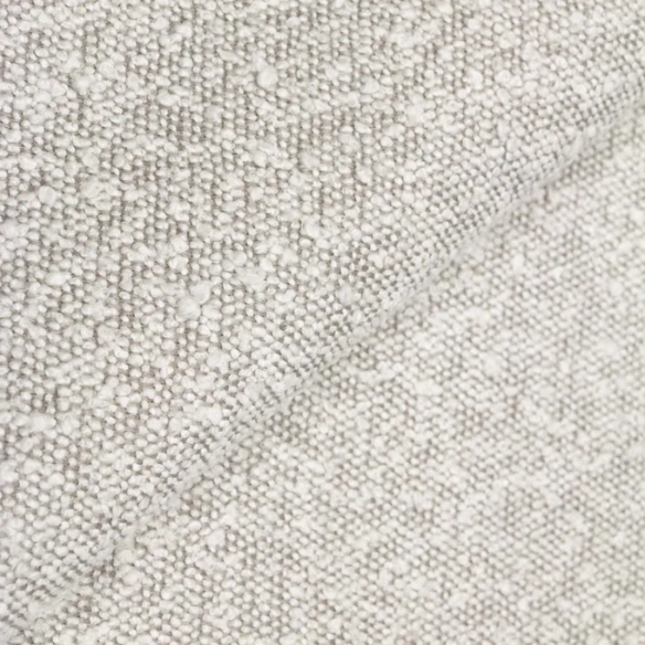 Ivory king-size upholstered bed in bouclé fabric with wingback headboard and low-profile black metal legs.

