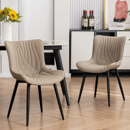 Set of 2 khaki faux leather dining chairs with fishtail tufted backs and black metal legs, styled for modern and transitional interiors.

