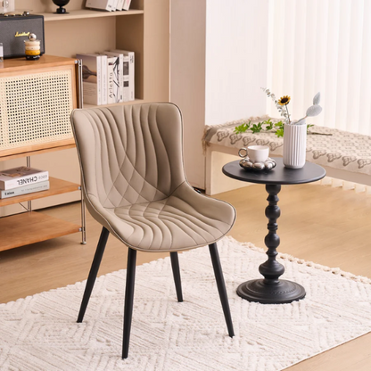 Set of 2 khaki faux leather dining chairs with fishtail tufted backs and black metal legs, styled for modern and transitional interiors.

