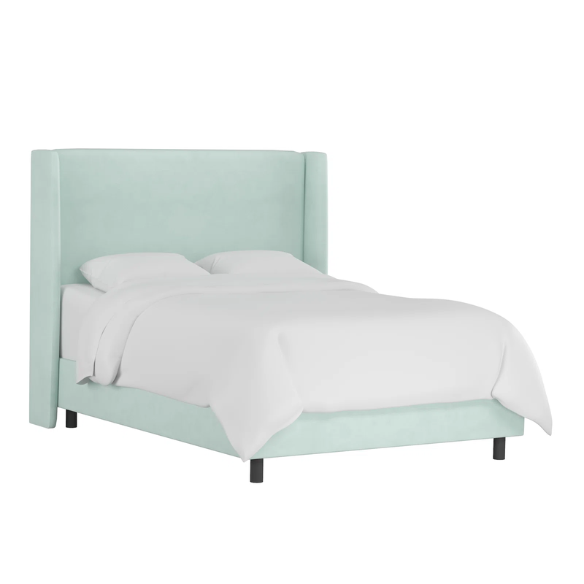 Light aqua king-size upholstered bed in velvet fabric with wingback headboard and low-profile black metal legs.

