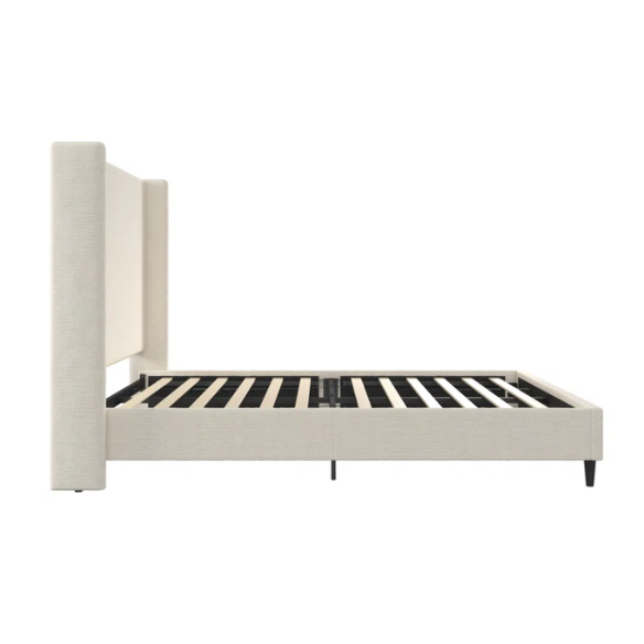 Light cream boucle queen-size platform bed with tall wingback tufted headboard and black tapered legs.

