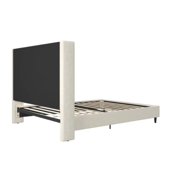 Light cream boucle queen-size platform bed with tall wingback tufted headboard and black tapered legs.

