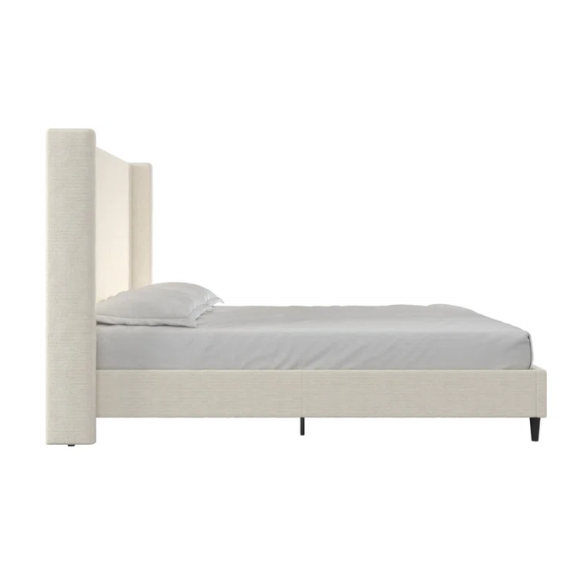 Light cream boucle queen-size platform bed with tall wingback tufted headboard and black tapered legs.


