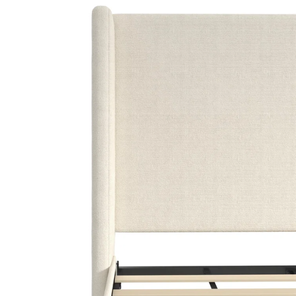 Light cream boucle queen-size platform bed with tall wingback tufted headboard and black tapered legs.

