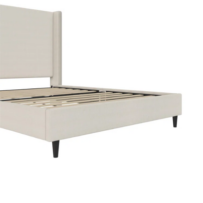 Light cream canvas upholstered queen-size bed with extra-tall wingback tufted headboard and black tapered legs.

