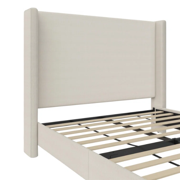 Light cream canvas upholstered queen-size bed with extra-tall wingback tufted headboard and black tapered legs.

