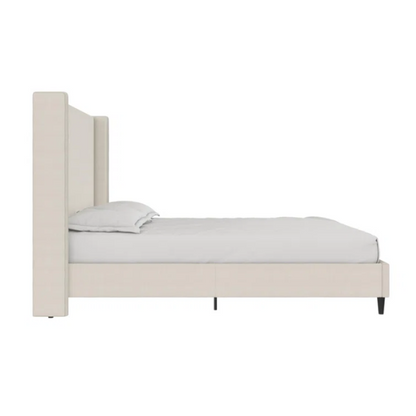 Light cream canvas upholstered queen-size bed with extra-tall wingback tufted headboard and black tapered legs.

