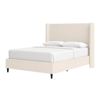 Light cream canvas upholstered queen-size bed with extra-tall wingback tufted headboard and black tapered legs.

