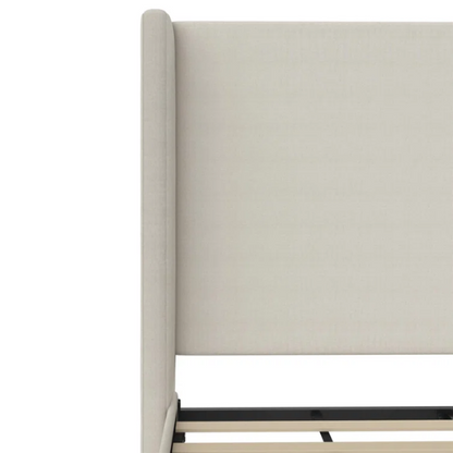 Light cream canvas upholstered queen-size bed with extra-tall wingback tufted headboard and black tapered legs.

