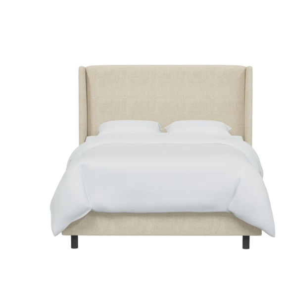 Light cream king-size upholstered bed in textured tweed fabric with wingback headboard and low-profile black metal legs.

