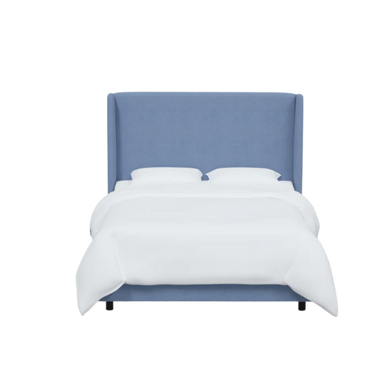 Light denim blue king-size upholstered bed in linen fabric with wingback headboard and low-profile black metal legs.

