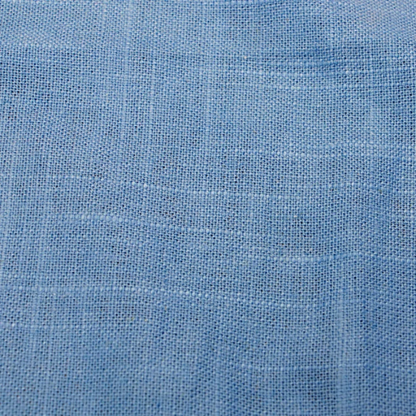Light denim blue king-size upholstered bed in linen fabric with wingback headboard and low-profile black metal legs.

