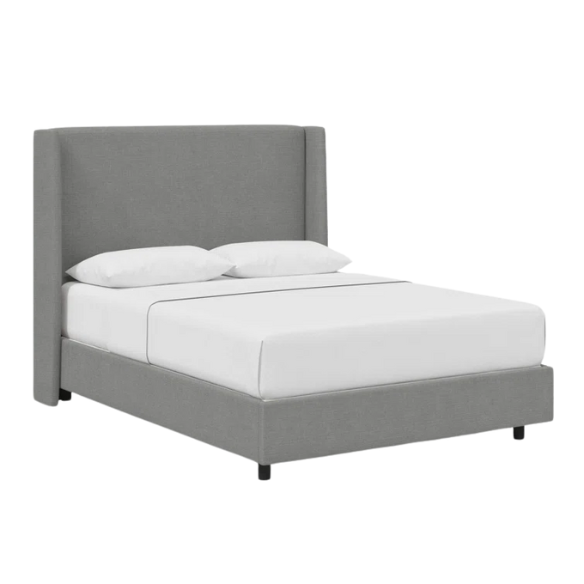 Light grey king-size upholstered bed in linen fabric with wingback headboard and low-profile black metal legs.

