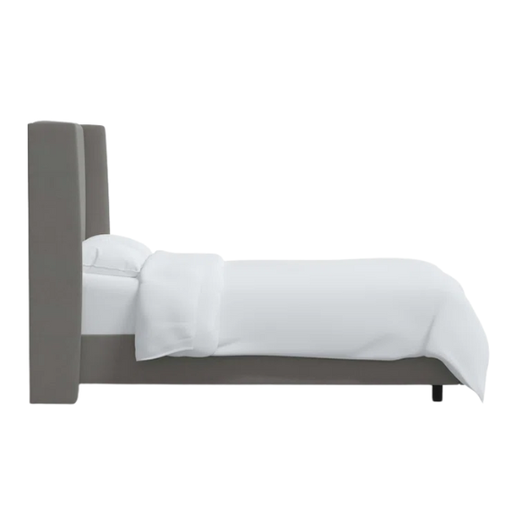 Light grey king-size upholstered bed in linen fabric with wingback headboard and low-profile black metal legs.

