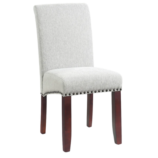Light grey upholstered Parsons chair with scrolled high back, antique bronze nailhead trim, and solid wood legs