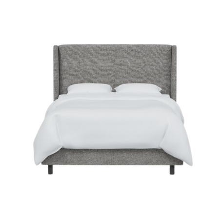 Light grey king-size upholstered bed in tweed fabric with wingback headboard and low-profile black metal legs.

