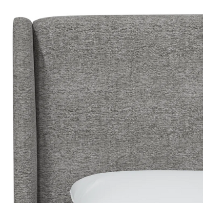 Light grey king-size upholstered bed in tweed fabric with wingback headboard and low-profile black metal legs.

