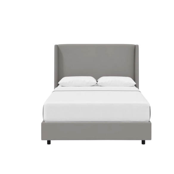 Light grey king-size upholstered bed in velvet fabric with wingback headboard and low-profile black metal legs.

