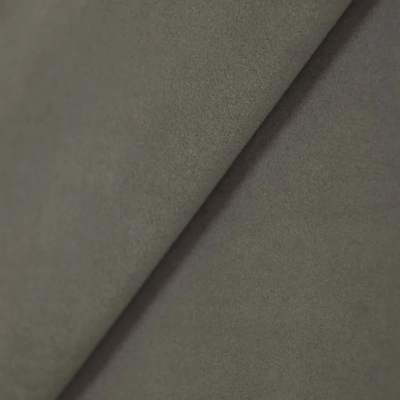 Light grey king-size upholstered bed in velvet fabric with wingback headboard and low-profile black metal legs.

