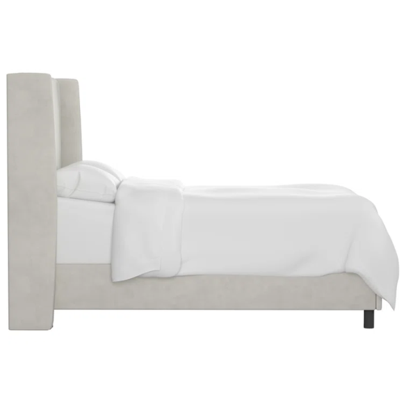 Light grey king-size upholstered bed with performance velvet fabric, wingback headboard, and low-profile black metal legs.

