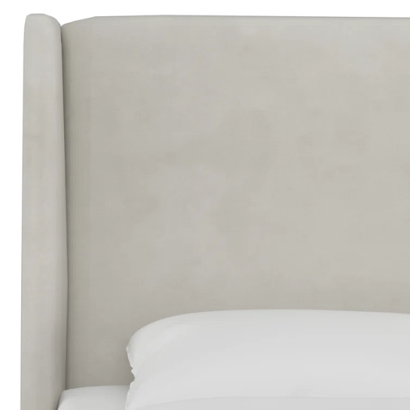 Light grey king-size upholstered bed with performance velvet fabric, wingback headboard, and low-profile black metal legs.

