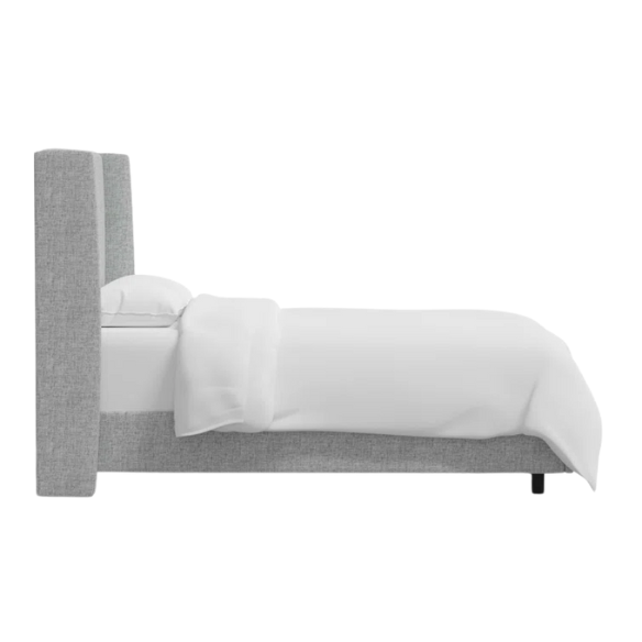 Light natural grey king-size upholstered bed in linen with wingback headboard and black metal legs.

