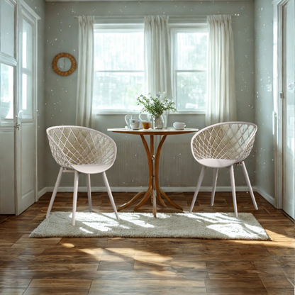 Set of two matte white mid-century modern dining chairs with molded plastic seats and black metal legs.

