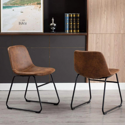 Set of two modern dining chairs upholstered in brown faux leather with curved backrests and black metal legs.

