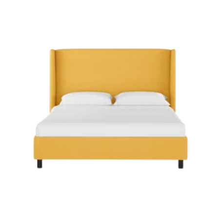 Mustard yellow king-size upholstered bed in linen fabric with wingback headboard and low-profile black metal legs.

