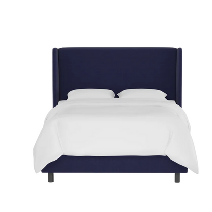 Navy blue king-size upholstered bed in twill fabric with wingback headboard and low-profile black metal legs.

