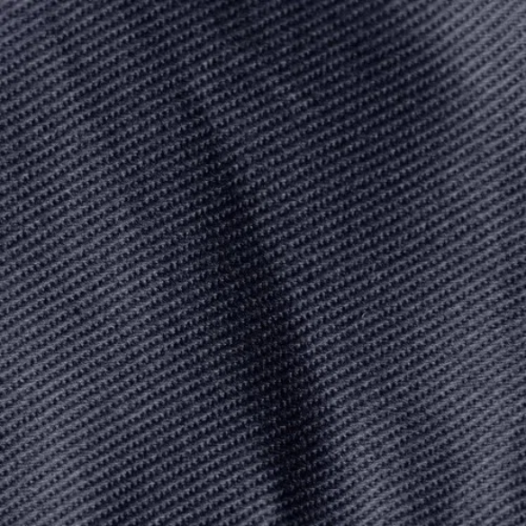 Navy blue king-size upholstered bed in twill fabric with wingback headboard and low-profile black metal legs.

