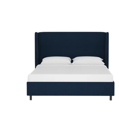 Navy blue king-size upholstered bed in velvet fabric with wingback headboard and low-profile black metal legs.

