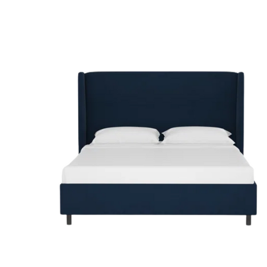 Navy blue king-size upholstered bed in velvet fabric with wingback headboard and low-profile black metal legs.

