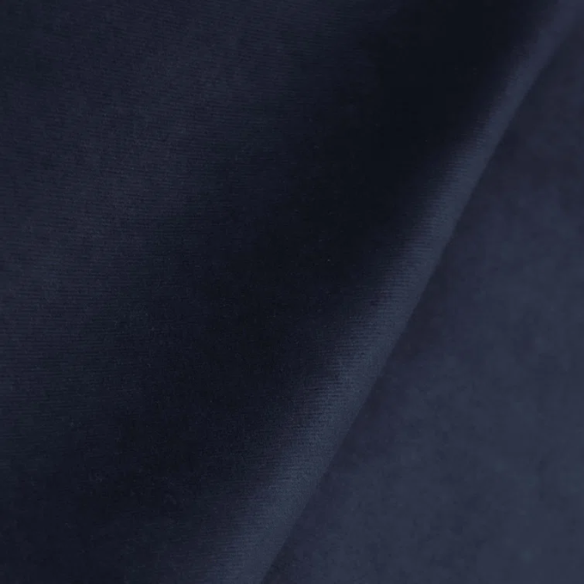 Navy blue king-size upholstered bed in velvet fabric with wingback headboard and low-profile black metal legs.

