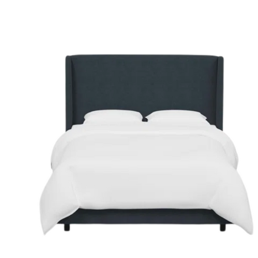 Navy king-size upholstered bed in linen fabric with wingback headboard and black metal legs.

