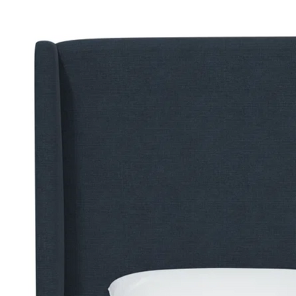 Navy king-size upholstered bed in linen fabric with wingback headboard and black metal legs.

