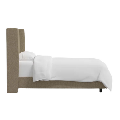 Neutral tan king-size upholstered bed in linen fabric with wingback headboard and black metal legs.

