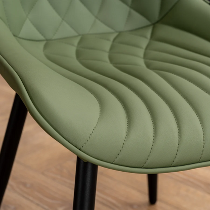 Set of 2 olive drab green faux leather dining chairs with fishtail backrest and metal legs, styled for a modern and mid-century inspired interior.

