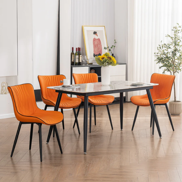 Set of 2 orange and black dining chairs with faux leather fishtail backs and metal legs, perfect for modern and contemporary interiors.

