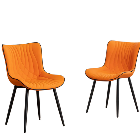 Set of 2 orange and black dining chairs with faux leather fishtail backs and metal legs, perfect for modern and contemporary interiors.

