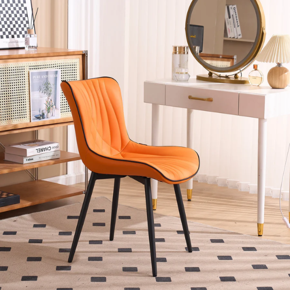 Set of 2 orange and black dining chairs with faux leather fishtail backs and metal legs, perfect for modern and contemporary interiors.

